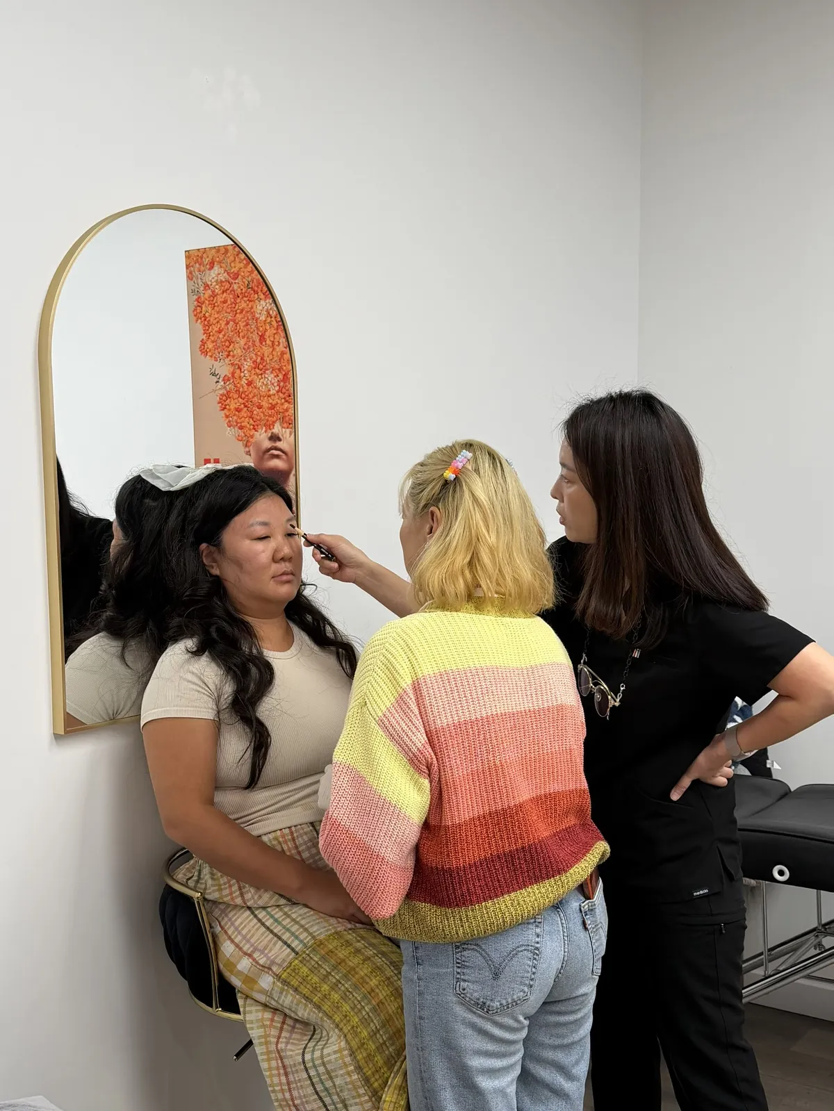 Instructor reviewing a student's eyebrow mapping on a live model during PMU training at SUNNYBROW Academy, Los Angeles